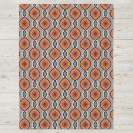 Tagesdecke mit geometrischem Muster in Rot, Orange, Blau auf grauem Hintergrund – mediterran & rhythmisch

